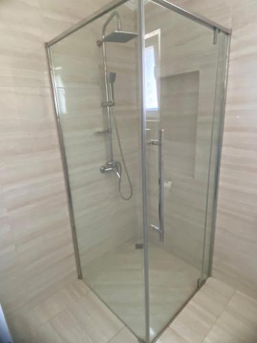 a shower with a glass door in a bathroom at Tivat apartman in Tivat