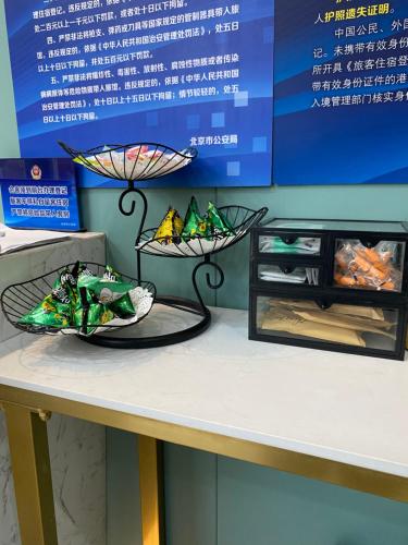 a table with two bowls on top of a table at Dequan Hotel Chaoyang Park Branch Coffee fruits, snacks a gym and a laundry room are provided for free in the lobby in Beijing