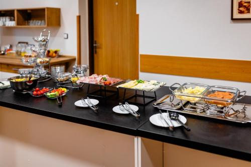 a buffet with several dishes of food on a counter at hotel Dobruška in Dobruška