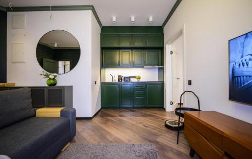 a living room with green cabinets and a couch at Marijas Designer Apartment - Quiet Luxury in the Heart of Riga in Rīga