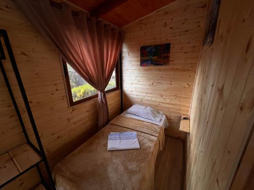 a small room with a bed in a wooden cabin at Wooden Home Nesti in Krujë
