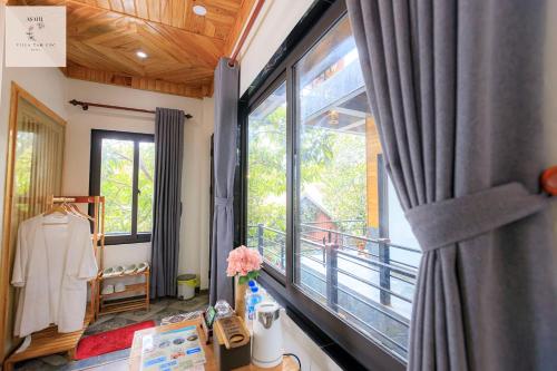 a room with a large window and a balcony at Asahi Villa Tam Coc in Ninh Binh
