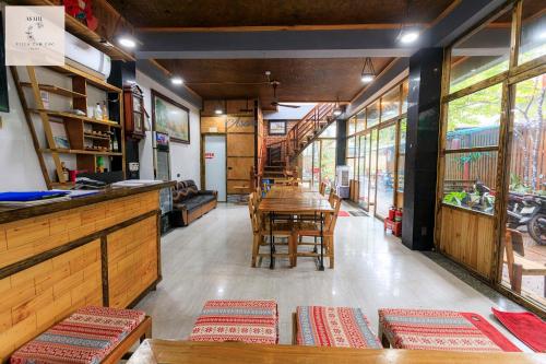 a restaurant with a table and chairs in a room at Asahi Villa Tam Coc in Ninh Binh