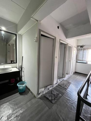a bathroom with a sink and a mirror at The New Normal House in Chiang Mai