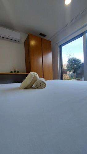 a bedroom with a bed with a towel on it at Welcome Douro - Eco Camping Resort in Cinfães