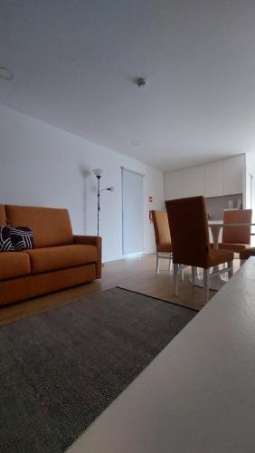 a living room with a couch and a table and chairs at Welcome Douro - Eco Camping Resort in Cinfães