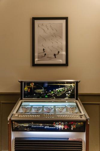 a close up of a machine with a picture on the wall at Le Falcoz in Saint-Jean-de-Maurienne