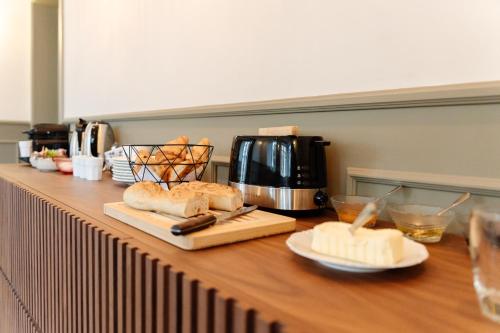 a kitchen counter with bread and a coffee maker and a counter top with bread at Le Falcoz in Saint-Jean-de-Maurienne