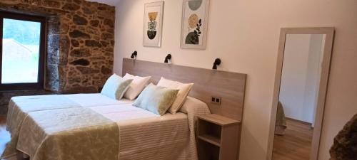 a bedroom with a large bed in a room at Mar do Val in Muxia