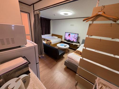 a small room with a bedroom and a living room at hostel sunflower 302 in Osaka