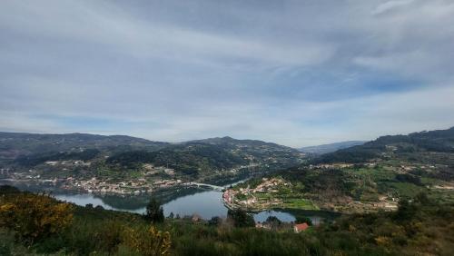 a view of a river and a town in a valley at Welcome Douro - Eco Camping Resort in Cinfães
