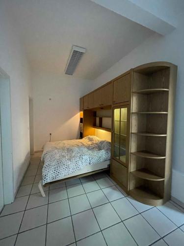 a bedroom with a bed and a book shelf at Atelier Suite in Reutlingen