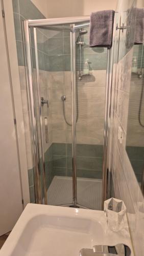 a bathroom with a shower and a white sink at BolognaFiera in Bologna