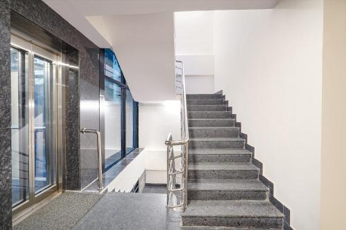 a set of stairs in a building with a glass door at Oriva Joven's Central - Brigade Road in Bengaluru