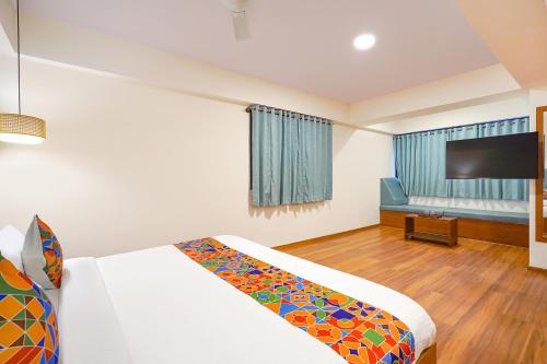 a hotel room with a bed and a flat screen tv at Oriva Joven's Central - Brigade Road in Bengaluru