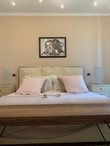 a bedroom with a large bed with two cats laying on it at La Villa vacation home Lake Como in Como