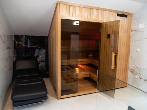 a large wooden cabinet with black seats in a room at Villa Agata in Lovran