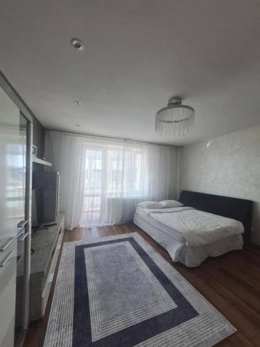 a bedroom with two beds and a television and a rug at Апартаменти біля автостанції Кравчука, 40 in Lutsk
