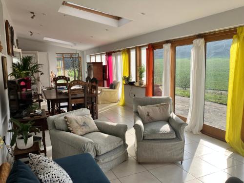 a living room with a couch and chairs and a table at Spring Valley Farm in Quatford