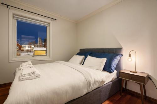a bedroom with a large bed and a window at ARCTIC HOMES - Villa Borealis in Tromsø