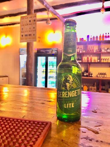 a bottle of beer sitting on top of a table at Triple A visitors in Kilindoni