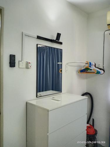 a mirror on top of a dresser in a room at Cozy Homestay#5 single bed#Batu Kawan Penang in Simpang Ampat