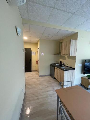 an empty room with a kitchen and a hallway at Estudios 85 - Cerca de Madrid, Toledo y Parque Warner in Parla