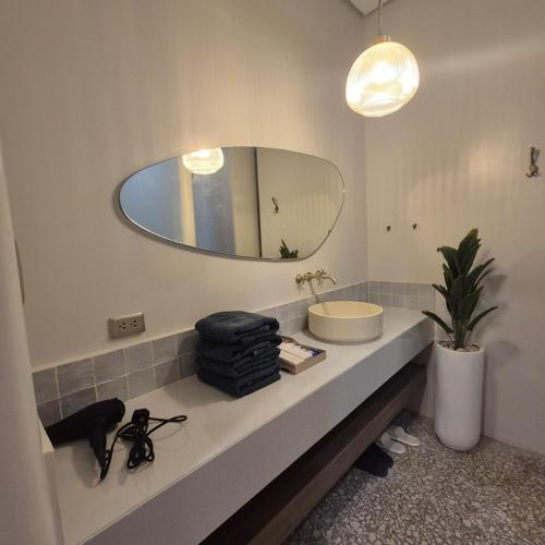 a bathroom with a sink and a mirror at Greek Villa with Pool and Jacuzzi in Davao City