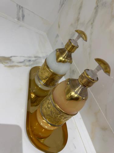two gold water faucets on a bathroom sink at Riad le marin Coucou beach in Agadir