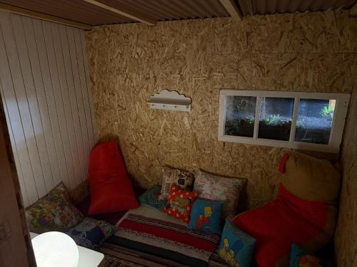 a small room with two windows and a couch at Glamping Finca el Olivo in Mijas