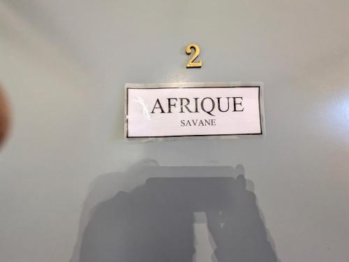 a sign that reads antique swampasy on a white wall at Chateau de Quesmy in Quesmy