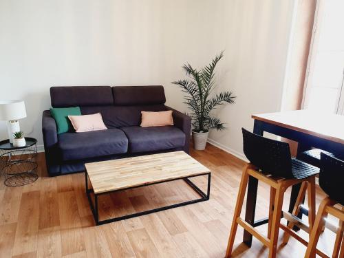 un salon avec un canapé et une table basse dans l'établissement Appartement - La Rochelle, à La Rochelle