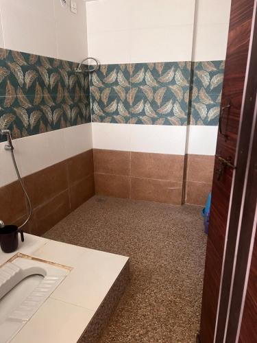 a bathroom with a sink and a shower at CozyNest Retreat in Belgaum