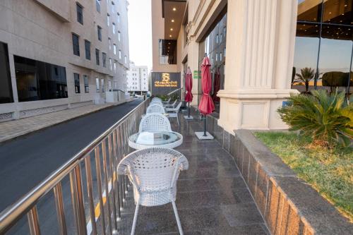 a row of tables and chairs on a balcony at Bellevue Park Hotel in Taif