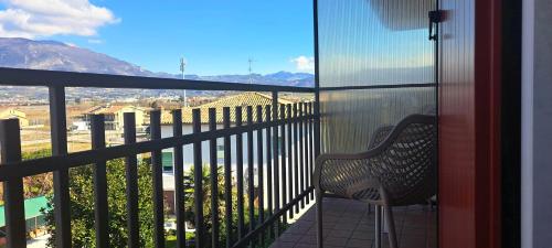 a balcony with a bench and a view of the mountains at Hotel B&B Fortuna in Costermano sul Garda