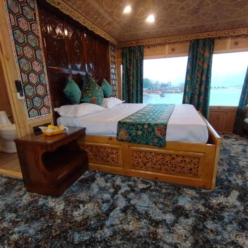 a bedroom with a large bed in a boat at HB Freedom group of Houseboats in Srinagar