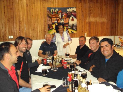 a group of people sitting around a table at Hosteria Rayen in La Junta