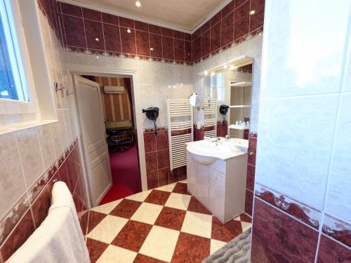 a bathroom with a sink and a mirror at Chateau de Quesmy in Quesmy