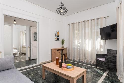 a living room with a couch and a table at Ether Seaside Apartment 2 in Pythagoreio