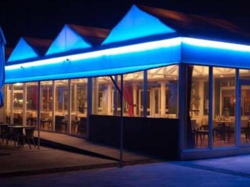 a building with blue lights on it at night at MOBIL HOME Le Soleil,3CH,6PERS in Port-la-Nouvelle