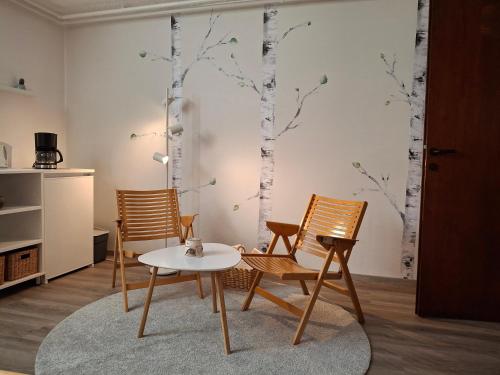 a living room with two chairs and a table at Prenočišče Breza in Radovljica