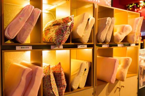 a display of socks and ties on shelves in a store at Grand Hotel Staymore -Adult Only in Natori