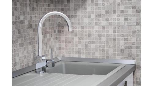 a bath tub with a faucet in a bathroom at Comfortable apartment in Umag with parking space in Murine