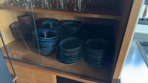a shelf filled with blue plates in a cabinet at AZUR 伊豆高原 paysage in Futo