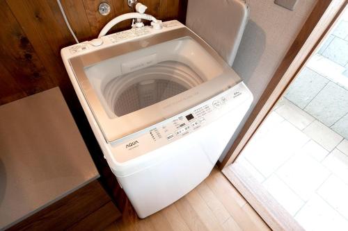 a washer and dryer sitting in a refrigerator at AZUR 伊豆高原 paysage in Futo