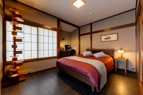 a bedroom with a bed and a large window at AZUR 伊豆高原 paysage in Futo