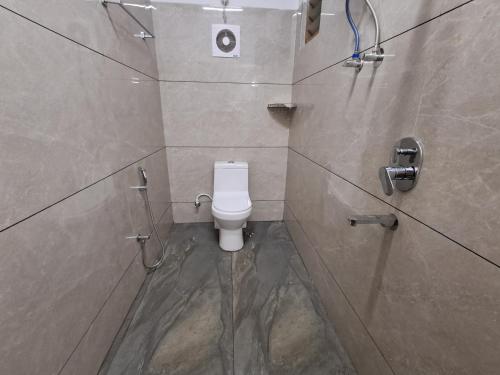 a bathroom with a white toilet in a shower at Raj Villa in Trivandrum