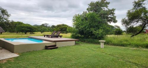 a bench sitting on a deck next to a pool at Heartland Self-catering Accommodation in Kampersrus AH