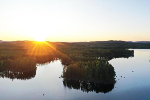 an aerial view of a lake at sunset at Haven Islands Treehouse on a private island in Torrflonäs