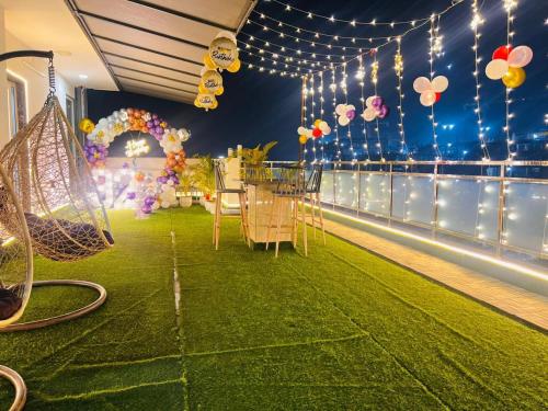 a room with a table and a green floor with lights at Hotel GreySky Near Medanta Hospital in Gurgaon
